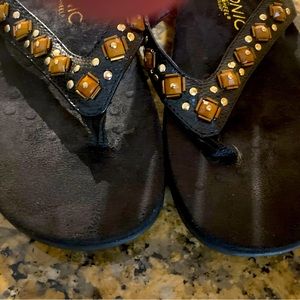 Black Vionic flip flops - gold and brown trim- size 7.